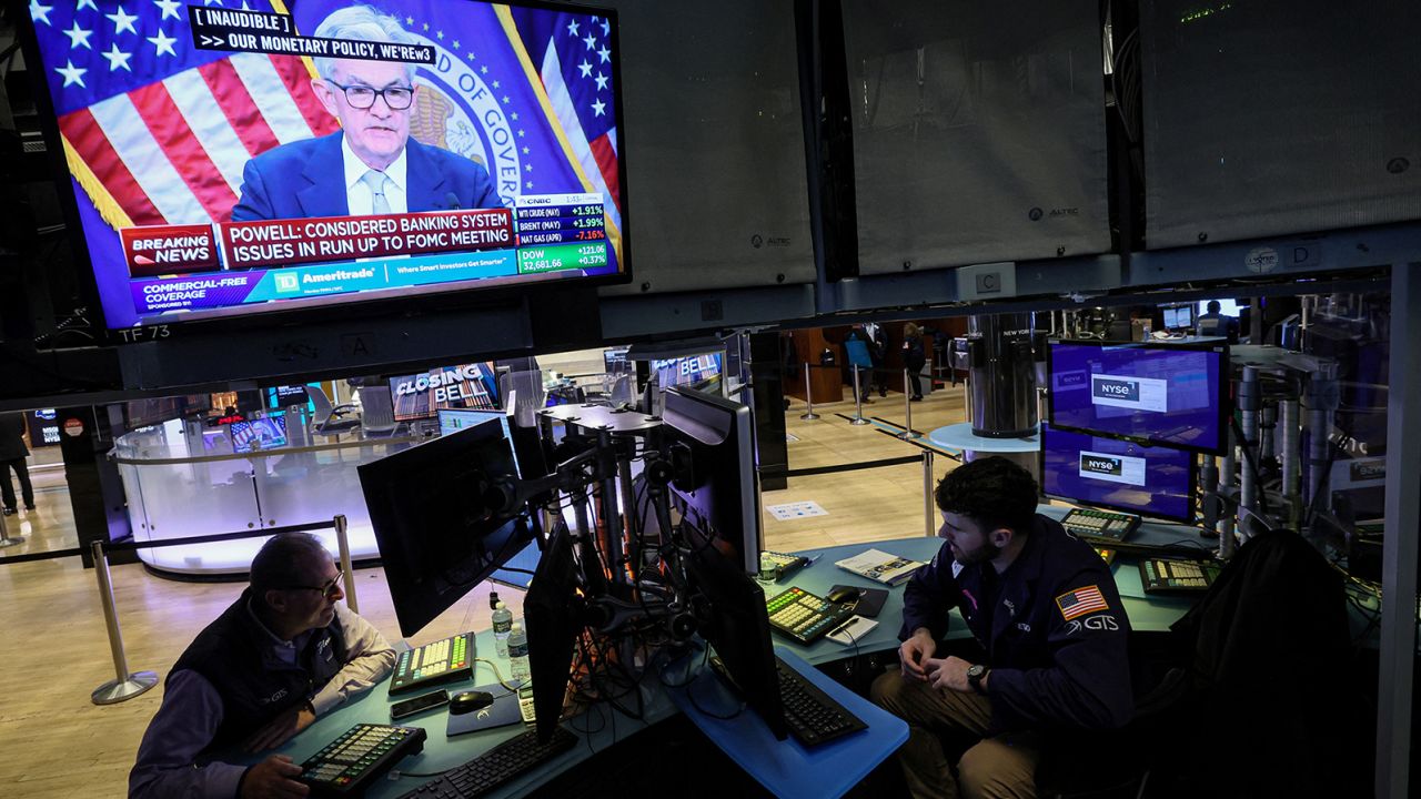 Traders react as Federal Reserve Chair Jerome Powell is seen delivering remarks on a screen, on the floor of the New York Stock Exchange (NYSE) in New York City, U.S., March 22, 2023.