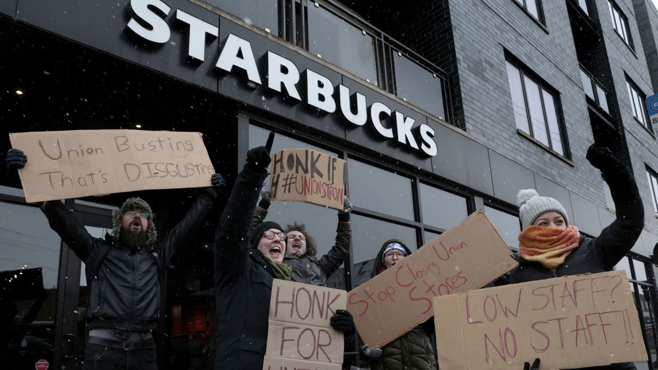 Starbucks employees react and cheer at the sound of honking motorists supporting them in a nationwide strike at the Starbucks at 1601 W. Irving Park Road on Dec. 16, 2022, in Chicago.