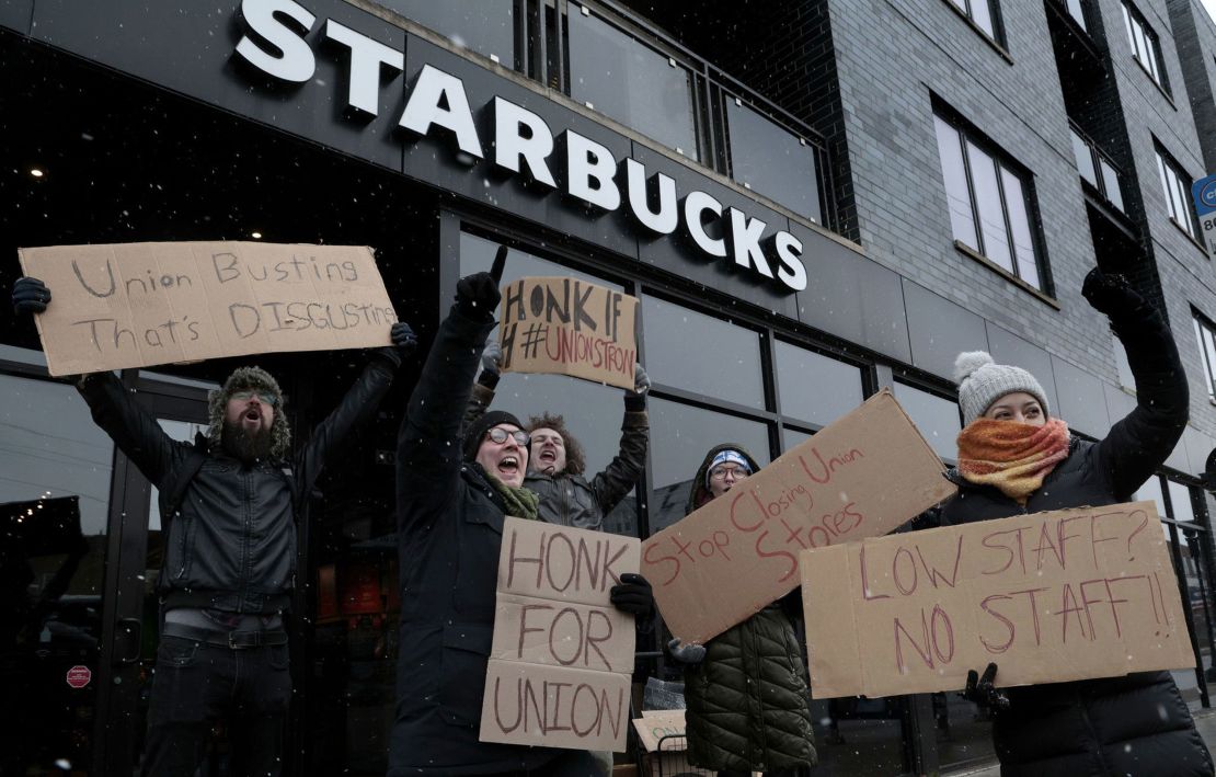 Starbucks employees react and cheer at the sound of honking motorists supporting them in a nationwide strike at the Starbucks at 1601 W. Irving Park Road on Dec. 16, 2022, in Chicago. 
