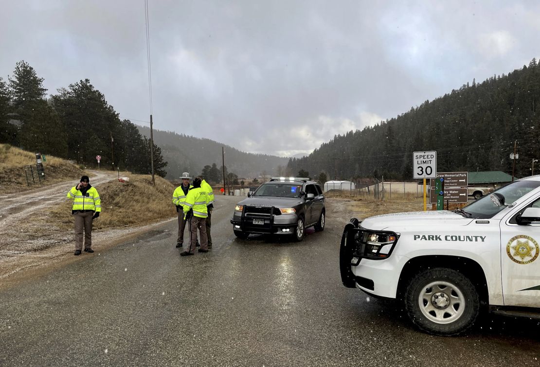 Deputies block a road in the town of Bailey, Colorado, where authorities found an abandoned car that belonged to the suspect in the shooting of two administrators at a Denver high school Wednesday.