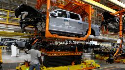The truck cab is lowered on the frame of Ford Motor Co. battery powered F-150 Lightning trucks under production at their Rouge Electric Vehicle Center in Dearborn, Michigan on September 20, 2022. 