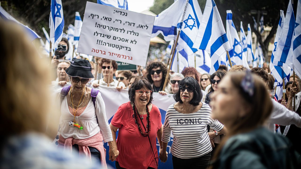 Women dance during protests against Netanyahu's controversial judicial reforms in Tel Aviv on March 22, 2023.