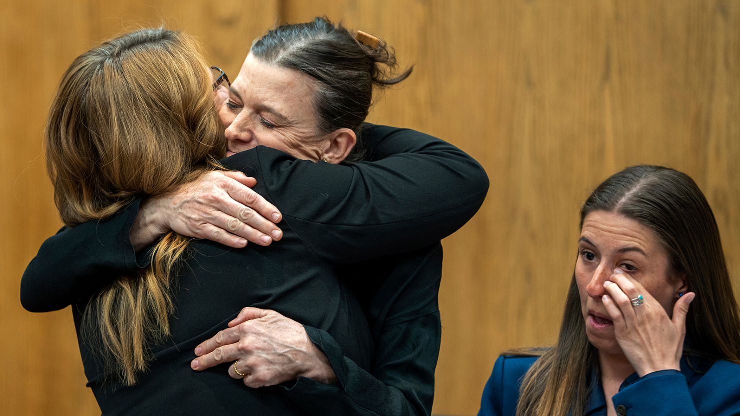 Dr. Giovannina Anthony, second from left, a plaintiff in a lawsuit challenging Wyoming's new near-total abortion ban, hugs her attorney after Teton County Judge Melissa Owens temporarily blocked the law on March 22, 2023.