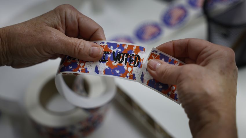 MILWAUKEE, WISCONSIN - NOVEMBER 06: Elections official Paula Volpiansky (C) tears apart "I VOTED" stickers at the Madison Central Public Library on the last day of early voting on November 06, 2022 in Milwaukee, Wisconsin. A record number of votes for a midterm election are expected to be cast across the United States. (Photo by Chip Somodevilla/Getty Images)