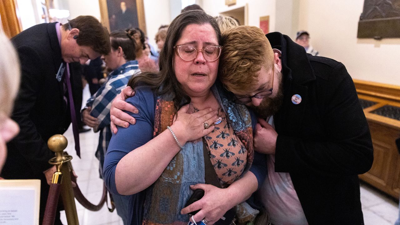 Christine Cox, a parent of a transgender teenager, becomes emotional after speaking to Georgia State Sen. Carden Summers outside the Senate at the Capitol in Atlanta on Monday. Activists appeared at the Capitol to protest against Senate Bill 140, a bill sponsored by Summers that would prevent medical professionals from giving transgender children certain hormones or surgical treatment.