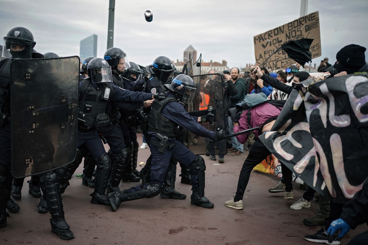 Protesters clash with police officers during a demonstration in Lyon, France, on Thursday, March 23.