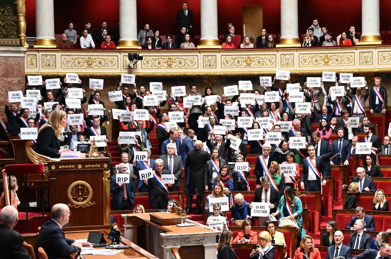Members of the French National Assembly hold signs after a no-confidence vote against President Emmanuel Macron's government on Monday, March 20. <a href="https://www.cnn.com/2023/03/20/world/macron-france-pension-no-confidence-intl/index.html" target="_blank">Two no-confidence votes failed</a>, clearing the way for Macron's pension reforms to be implemented.