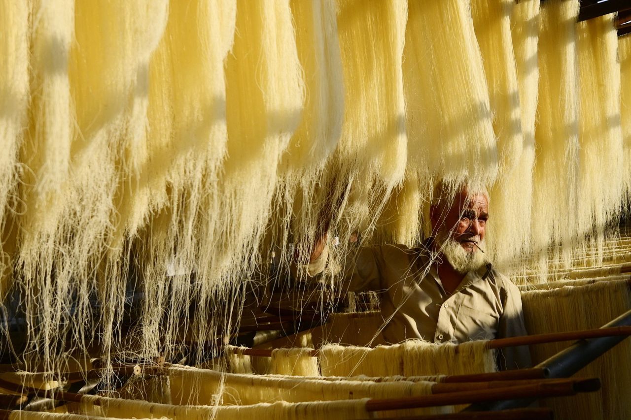A worker dries vermicelli at a factory in Prayagraj, India, on Wednesday, March 22. Vermicelli is used to make traditional sweet dishes during the Muslim holy month of Ramadan.