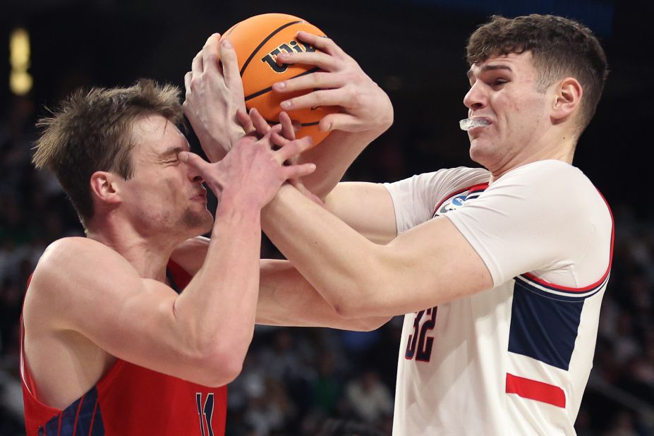 Saint Mary's Mitchell Saxen, left, and UConn's Donovan Clingan compete for a ball during an NCAA Tournament game on Sunday, March 19.