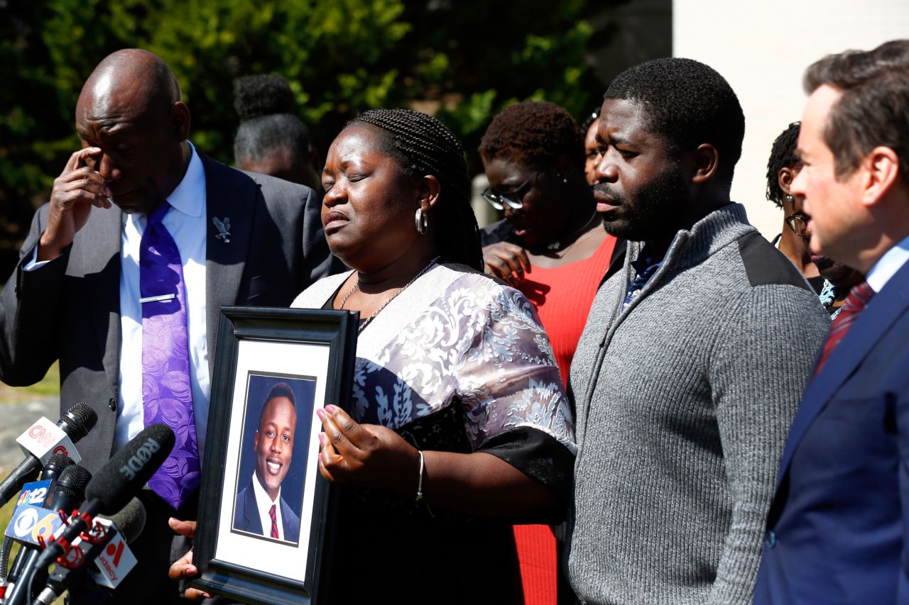 Caroline Ouko, the mother of Irvo Otieno, holds a portrait of her son during a news conference in Dinwiddie, Virginia, on Thursday, March 16. Otieno, 28, was smothered to death earlier this month at a state mental health facility, a prosecutor said. Seven Henrico County sheriff's deputies and three hospital security guards <a href="https://www.cnn.com/2023/03/20/us/irvo-otieno-family-virginia-death/index.html" target="_blank">have been charged with second-degree murder</a>. Otieno's family said the aspiring rapper was having a mental health crisis when he died.