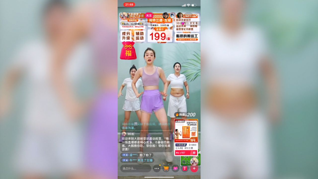 A fitness livestreamer on Douyin with products displayed on-screen.