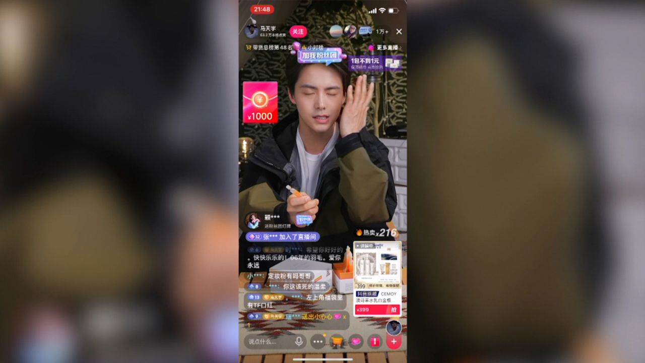 A Douyin livestreamer with product details displayed on screen.