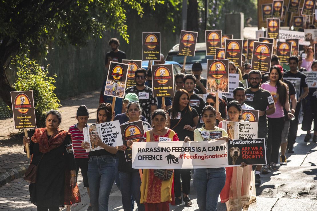 Animal lovers hold placards in protest of the Mumbai High Court's decision to ban the feeding of stray dogs in public places on November 6, 2022.