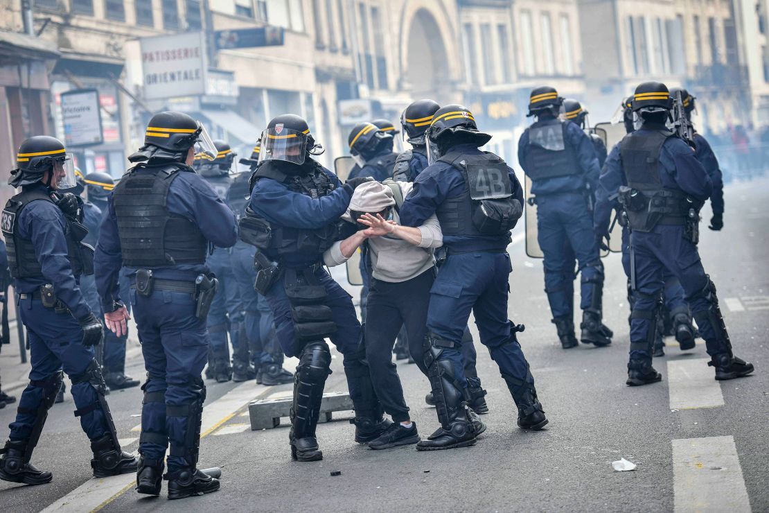 Anti-riot police arrest a man in Bordeaux during a demonstration on Thursday, a few days after the government pushed a pensions reform through French parliament without a vote. 