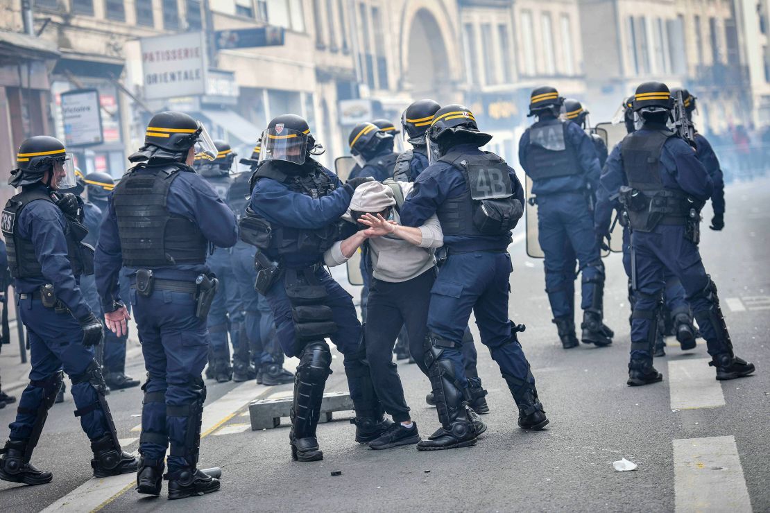 Anti-riot police arrest a man in Bordeaux during a demonstration on Thursday, a few days after the government pushed a pensions reform through French parliament without a vote.