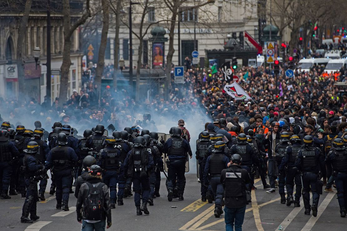Riot police face protesters outside Opera during a demonstration as part of a nationwide strike against pension reform in central Paris on Thursday.