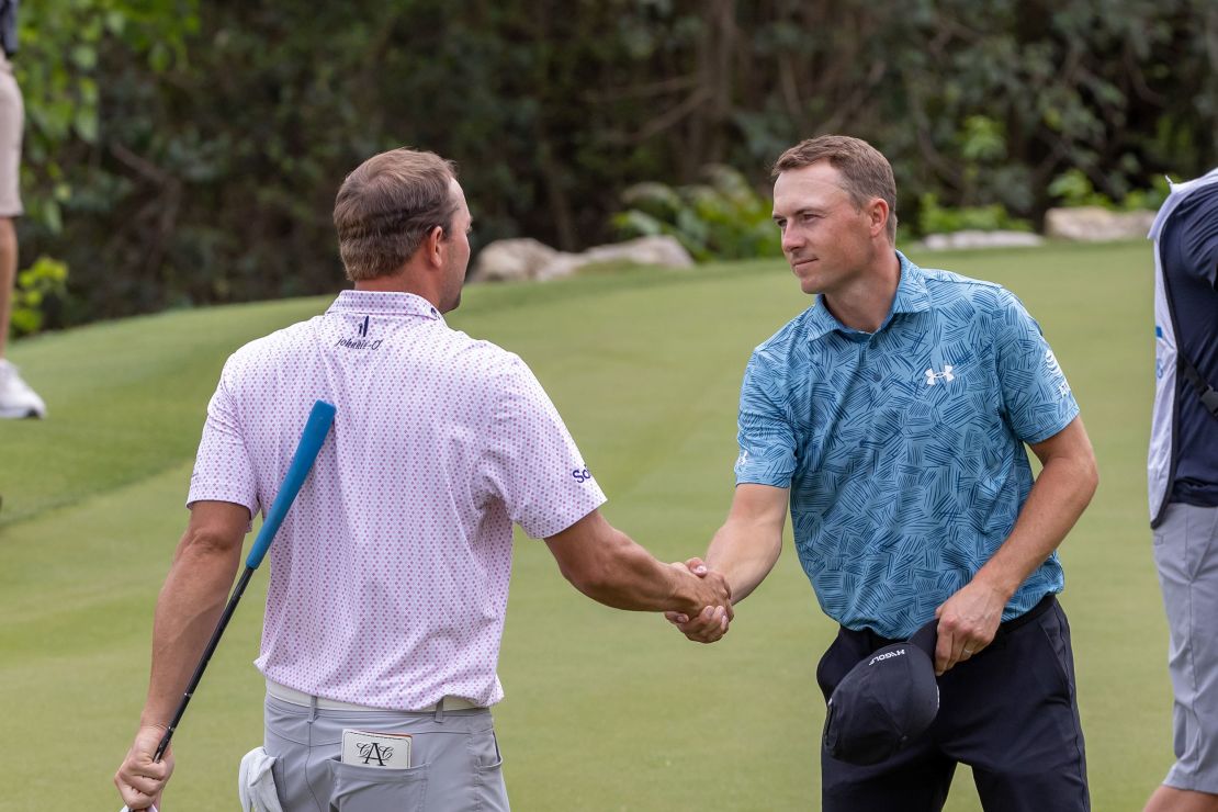 Spieth shakes hands with Montgomery after their round.