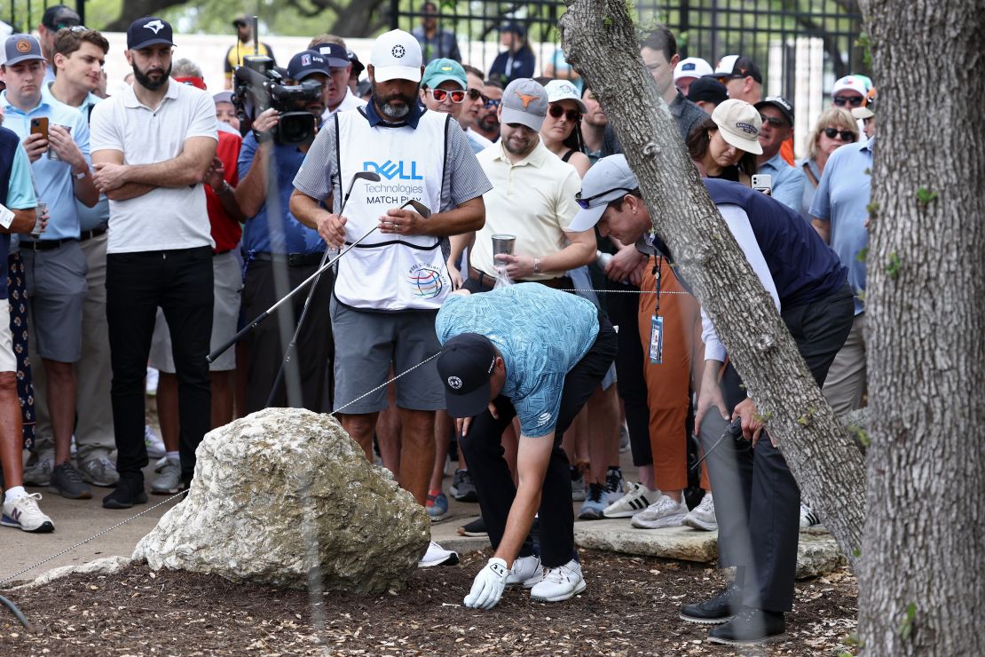 Spieth talks through his next move with a rules official.