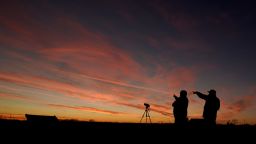 People are silhouetted against the sky at dusk as they watch the alignment of Saturn and Jupiter, Monday, Dec. 21, 2020, in Edgerton, Kan. The two planets are in their closest observable alignment since 1226. Appearing a tenth of a degree apart, the alignment known as the "great conjunction" has also been called the "Christmas Star." (AP Photo/Charlie Riedel)