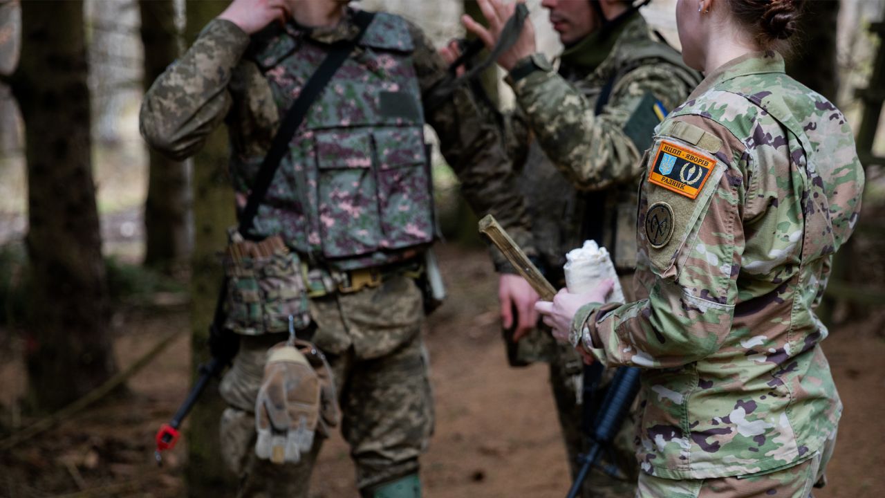 US Army Staff Sgt. Desirie Carson, a combat medic specialist assigned to Task Force Orion, 27th Infantry Brigade Combat Team, New York Army National Guard, instructs Armed Forces of Ukraine soldiers on how to apply a tourniquet during "all service member" medical training in Grafenwoehr, Germany, February 23, 2023. 