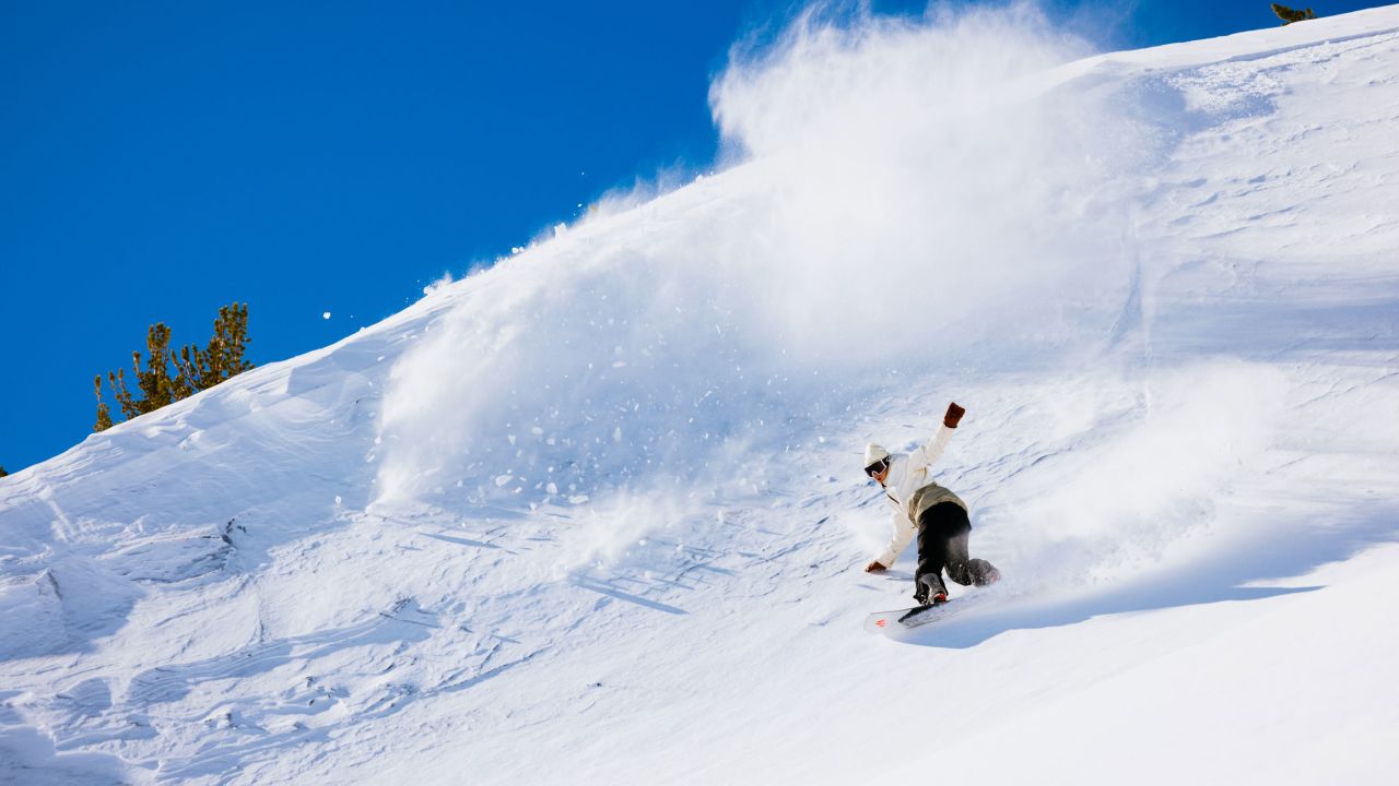 A snowboarder speeds down a run at Mammoth Mountain Ski Area.