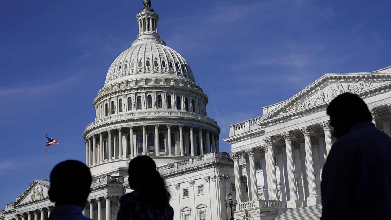 People walk outside the U.S. Capitol building in Washington on June 9, 2022. 