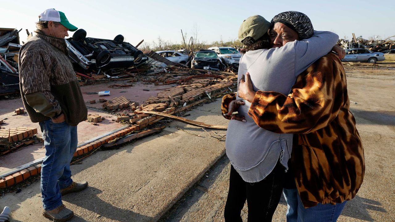 Tracy Hardin, center, who with her husband Tim, left, own Chuck's Dairy Bar, consoles a neighbor in Rolling Fork, Mississippi.