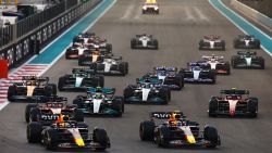 ABU DHABI, UNITED ARAB EMIRATES - NOVEMBER 20: Max Verstappen of the Netherlands driving the (1) Oracle Red Bull Racing RB18 and Sergio Perez of Mexico driving the (11) Oracle Red Bull Racing RB18 lead the field into turn one at the start during the F1 Grand Prix of Abu Dhabi at Yas Marina Circuit on November 20, 2022 in Abu Dhabi, United Arab Emirates.