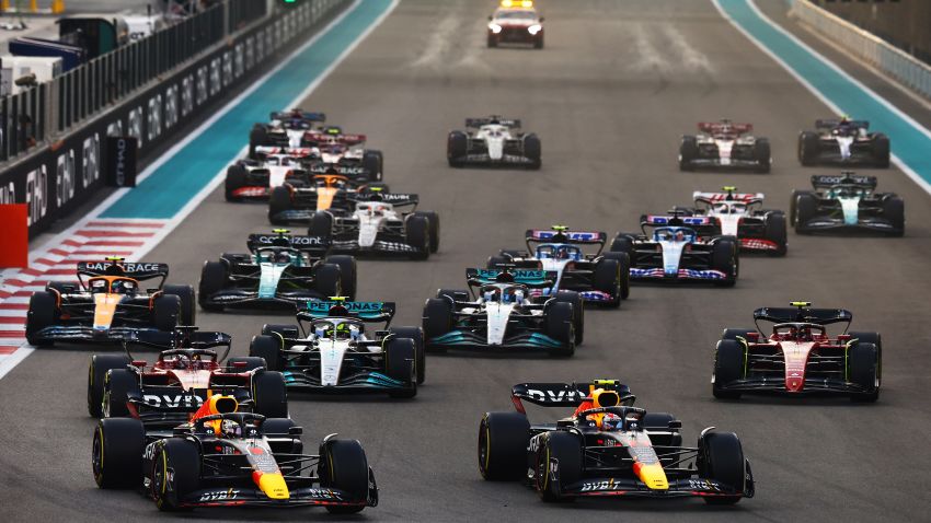 ABU DHABI, UNITED ARAB EMIRATES - NOVEMBER 20: Max Verstappen of the Netherlands driving the (1) Oracle Red Bull Racing RB18 and Sergio Perez of Mexico driving the (11) Oracle Red Bull Racing RB18 lead the field into turn one at the start during the F1 Grand Prix of Abu Dhabi at Yas Marina Circuit on November 20, 2022 in Abu Dhabi, United Arab Emirates.