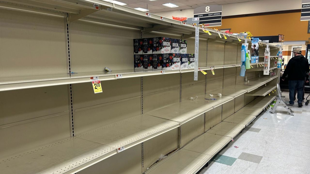 Water bottle shelves at a supermarket in Philadelphia sit empty Sunday following a chemical spill in the Delaware River.