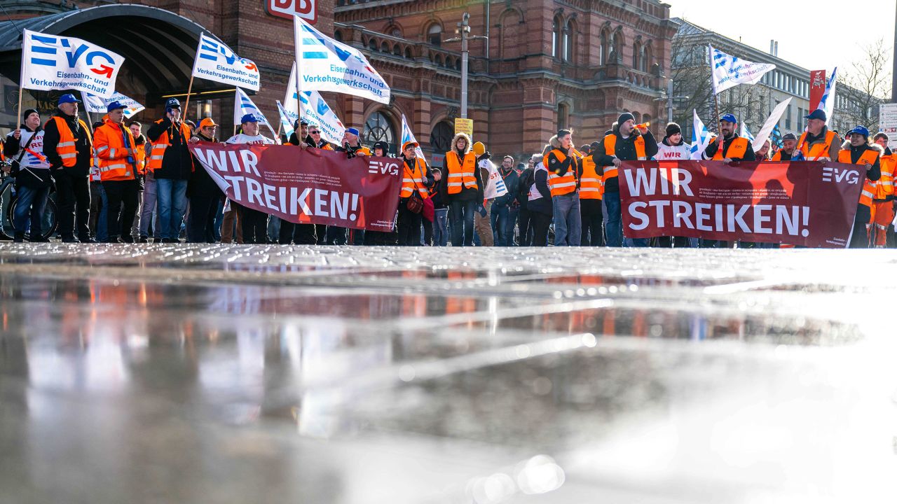 Demonstrators of the Railway and Transport Union stand with placards in front of the main train station in Bremen, Germany, on 27 March, 2023.