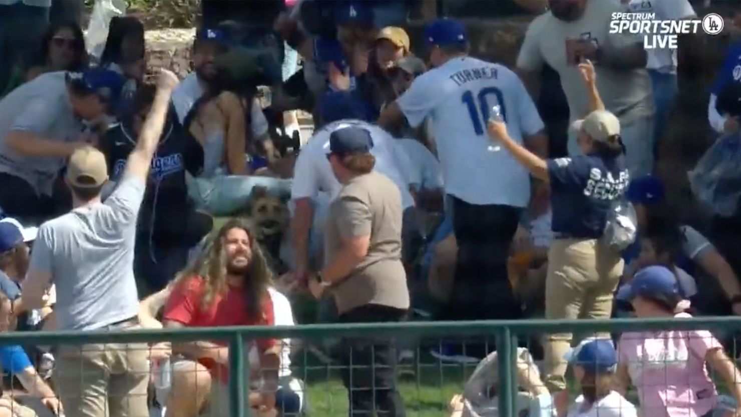 A dog catches the ball after a Dodgers prospect hits a home run. 