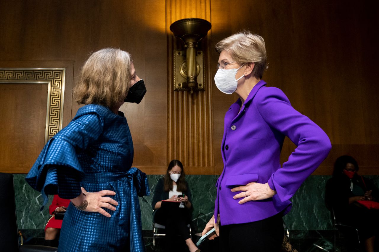 Sen. Elizabeth Warren talks with Federal Reserve's Board of Governors nominee Sarah Bloom Raskin before a Senate hearing in February 2022.
