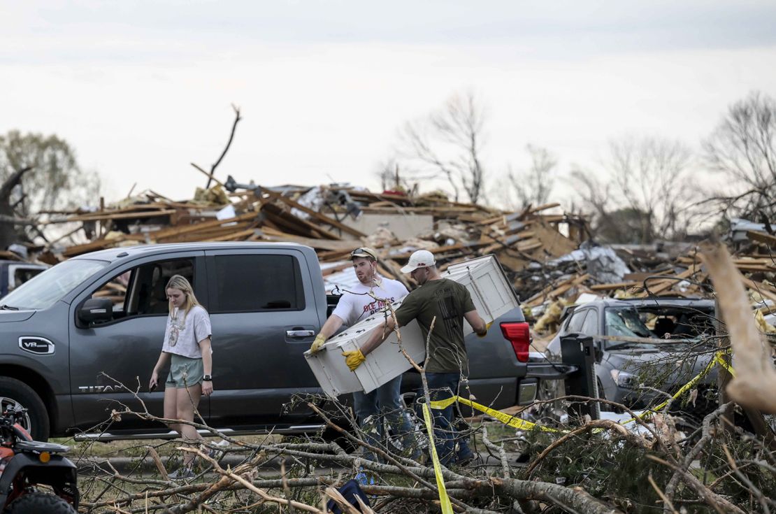 Storm victims assess the damage Sunday in Rolling Fork, Mississippi, where an EF-4 tornado struck the town over the weekend.