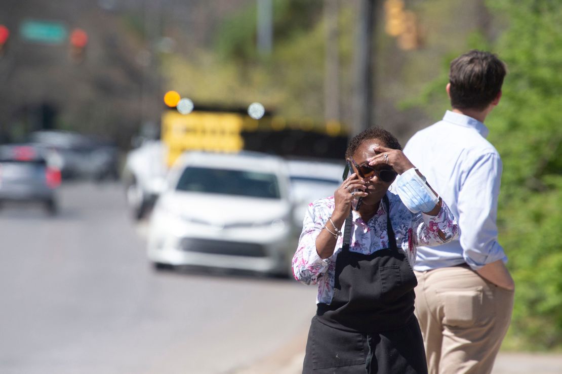 School staff wait near The Covenant School following a school shooting on Monday morning in Nashville.