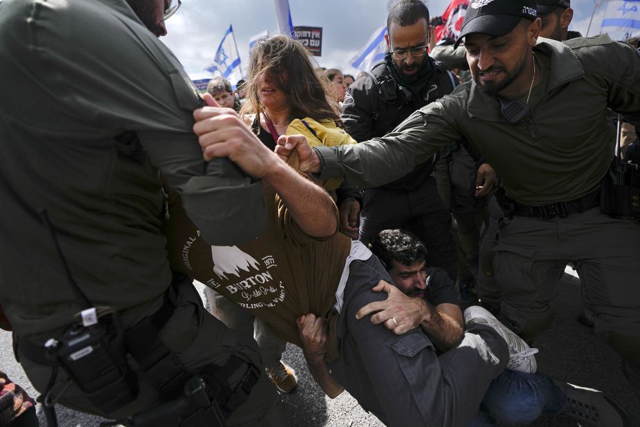 People scuffle with police in Jerusalem during a protest outside the Knesset, Israel's parliament, on Monday, March 27.