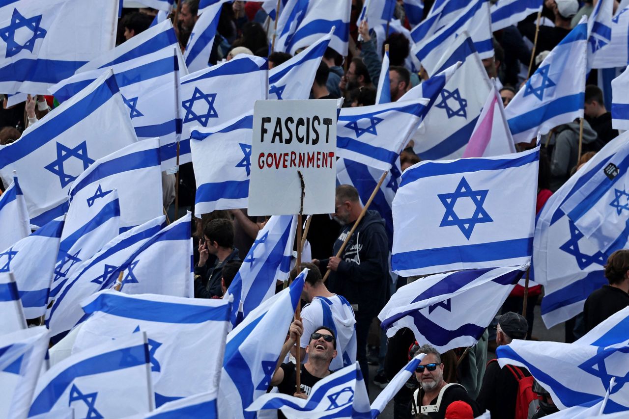 Protesters wave Israeli flags during a demonstration in Jerusalem on March 27.