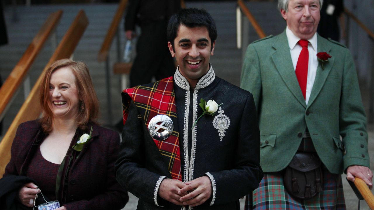 Humza Yousaf smiles as he walks down stairs after the Oath and Affirmation ceremony the Scottish Parliament in Edinburgh, Scotland May 11, 2011. 