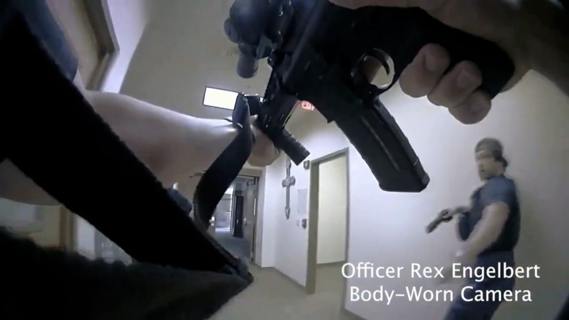 A Nashville officer wields his weapon during the school shooting response.