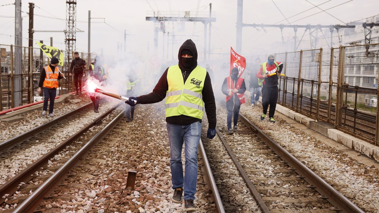 Railway workers demonstrate on the tracks at the Gare de Lyon train station, Tuesday, March 28, 2023 in Paris. A new round of strikes and demonstrations is planned against the unpopular pension reforms that, most notably, push the legal retirement age from 62 to 64. (AP Photo/Thomas Padilla)