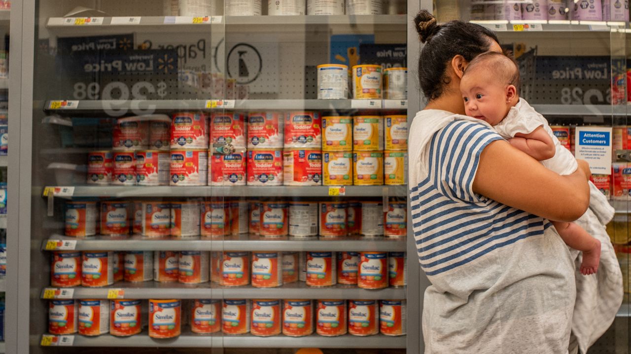 The Reyes family wait to receive baby formula in a Walmart Supercenter on July 8, 2022 in Houston, Texas. 