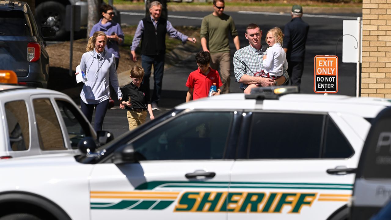 Families leave a reunification site in Nashville on Monday following the deadly school shooting.