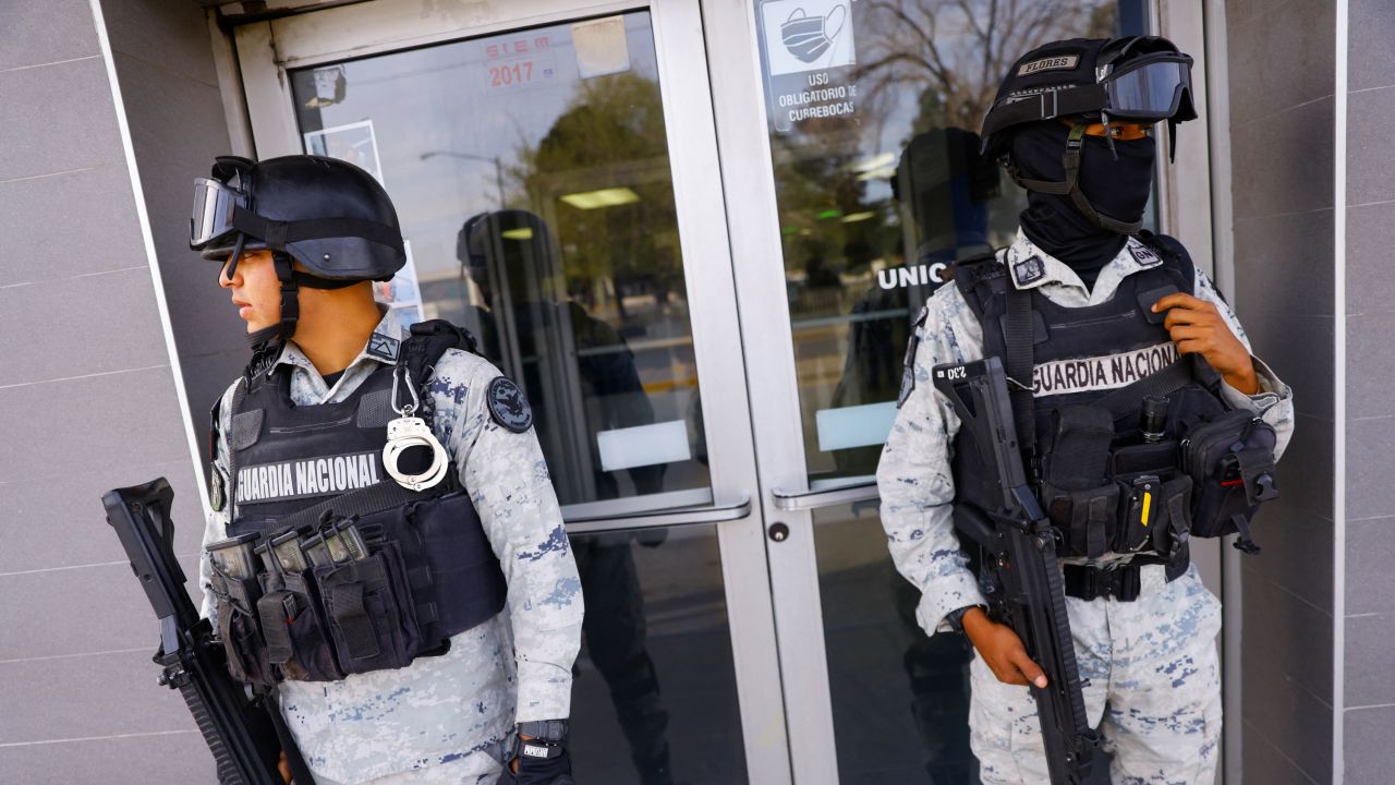 Members of the Mexican National Guard stand guard outside a hospital where injured migrants were being treated.