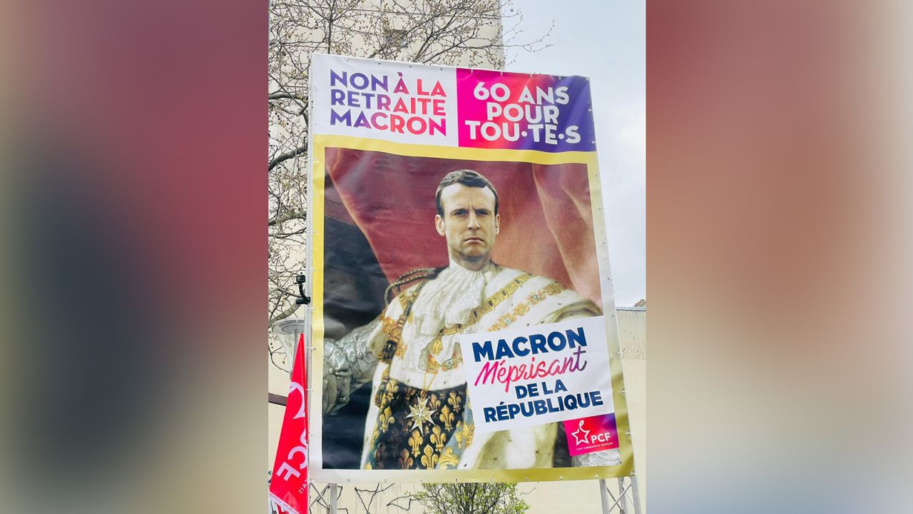 A poster of President Emmanuel Macron is waved at protests in Paris on Tuesday. It reads, "No to Macron's retirement. 60 for all. Macron despising the republic."