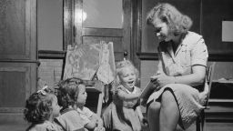 In this September 1942 photo, a child care worker reads a story at a child care center in New Britain, Connecticut. 