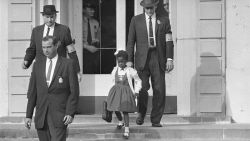 FILE - U.S. Deputy Marshals escort 6-year-old Ruby Bridges from William Frantz Elementary School in New Orleans, in this November 1960, file photo. New Orleans is marking the 61st anniversary of the integration of its public schools by four  6-year-old girls. Weekend events began with a Friday morning news conference at New Orleans City Hall and an evening screening of a video tribute to the four. A special church service and a motorcade are set for Sunday, Nov. 14, 2021. (AP Photo/File)