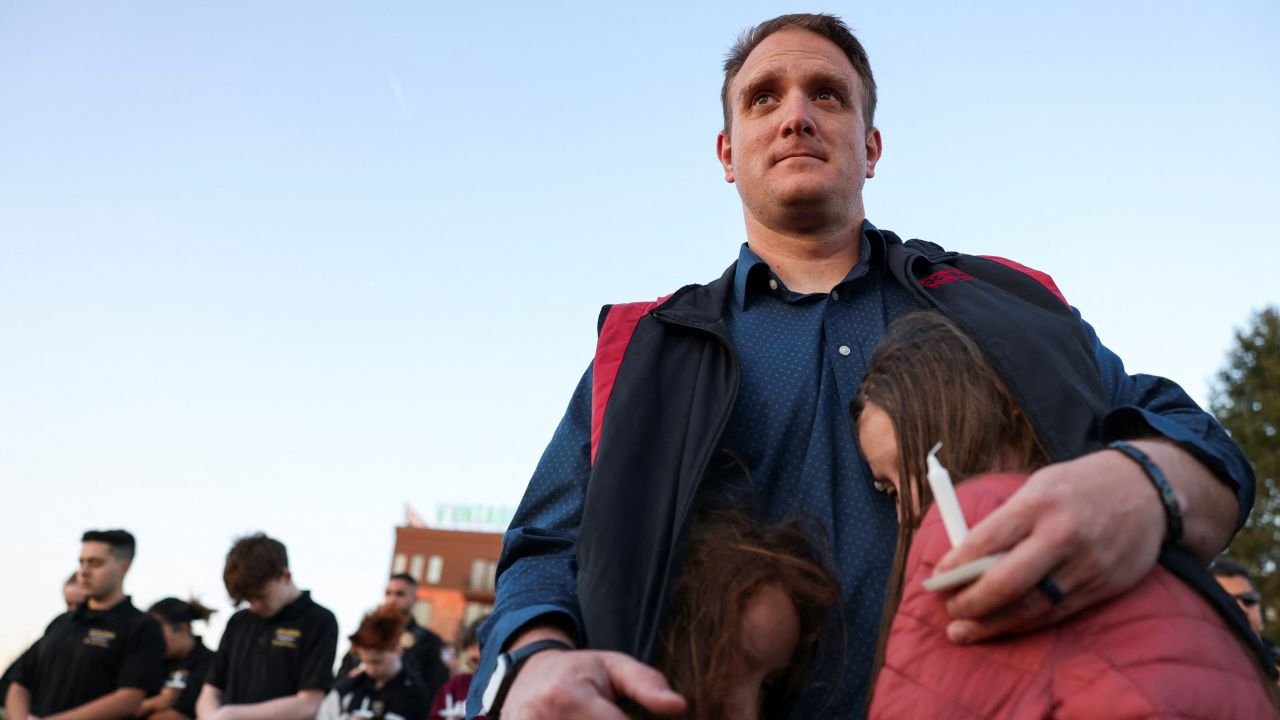 R.T. VanOrden and his daughters attend a vigil Tuesday for the victims of the Nashville mass shooting.