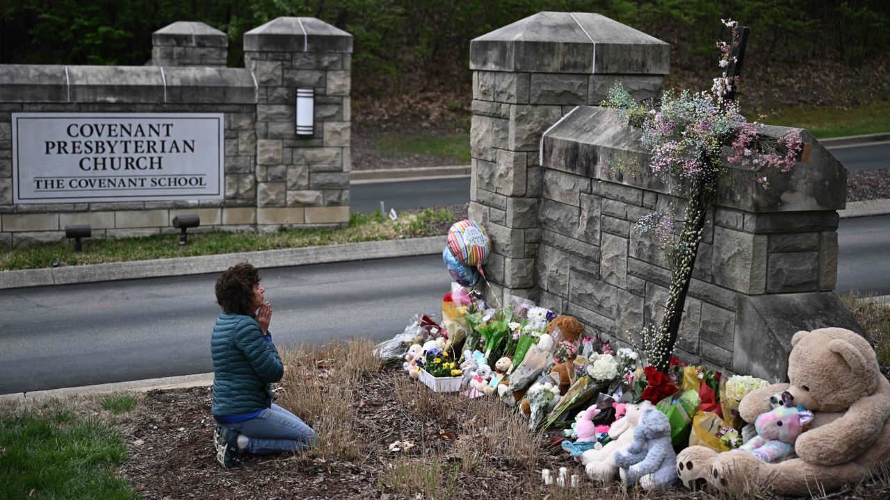 Robin Wolfenden prays at a makeshift memorial for victims outside the Covenant School building at the Covenant Presbyterian Church following a shooting, in Nashville, Tennessee, on Tuesday.