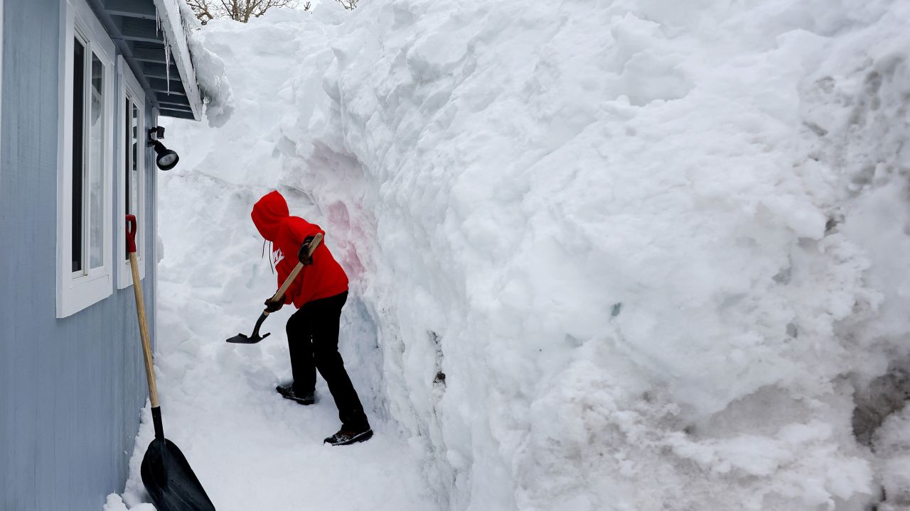 Robert Mendoza shovels out his neighbor's home in the Sierra Nevada mountains on Tuesday in Mammoth Lakes, California. 