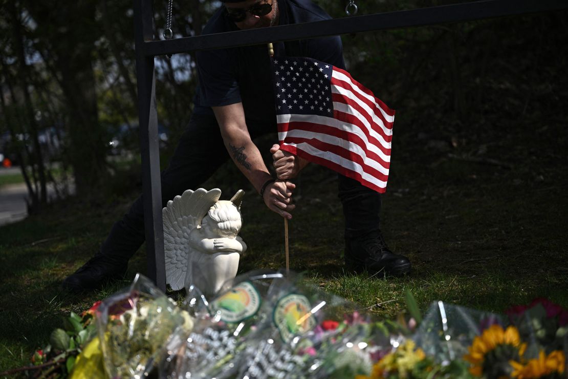 Bart Pike places an angel and a US national flag at a makeshift memorial for victims by the Covenant School building at the Covenant Presbyterian Church following a shooting, in Nashville, Tennessee, March 28, 2023. - A heavily armed former student killed three young children and three staff in what appeared to be a carefully planned attack at a private elementary school in Nashville on Monday, before being shot dead by police.
Chief of Police John Drake named the suspect as Audrey Hale, 28, who the officer later said identified as transgender.